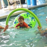 Family playing at an indoor pool.