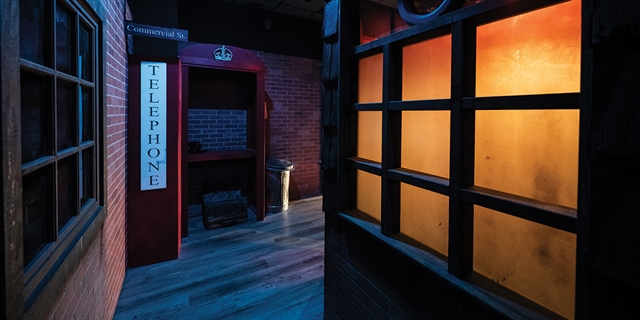 A dark room with a telephone booth.