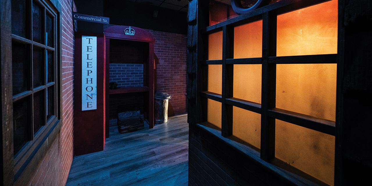 A dark room with a telephone booth.