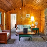 The living area and kitchen inside a cabin resort home.