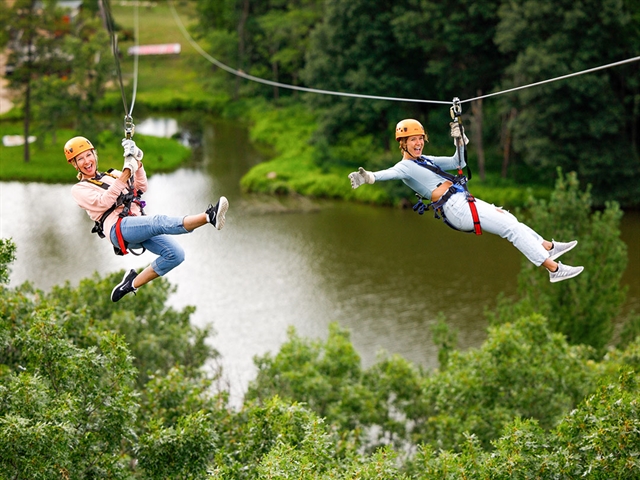 Women ziplining at BigFoot Ziplines in Wisconsin Dells.