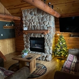 Cozy cabin interior with fireplace.