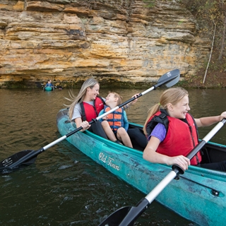 Family canoeing on Mirror Lake State Park.
