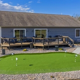 Vacation rental house with large patio and putting green in the front.