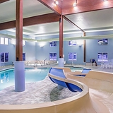 Indoor pool with waterslide.