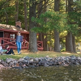People looking out to the lake from the shore.