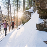 A couple goes cross-country skiing at Mirror Lake State Park.