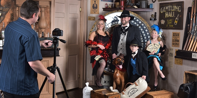 A family poses in old-time clothes.