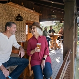 Couple enjoying beer on an outdoor deck.