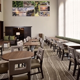 Commons and dining area with tables, chairs, and booths.