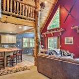 Cabin interior with duck decorations, kitchen space, and couches.