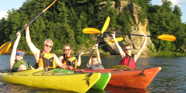 Family Kayaking on a lake with dells